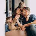 Young family with their sons at home having fun