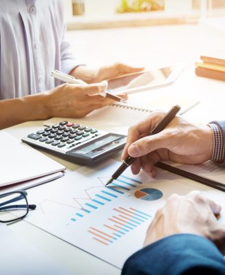business man financial inspector and secretary making report, calculating or checking balance. Internal Revenue Service inspector checking document. Audit concept